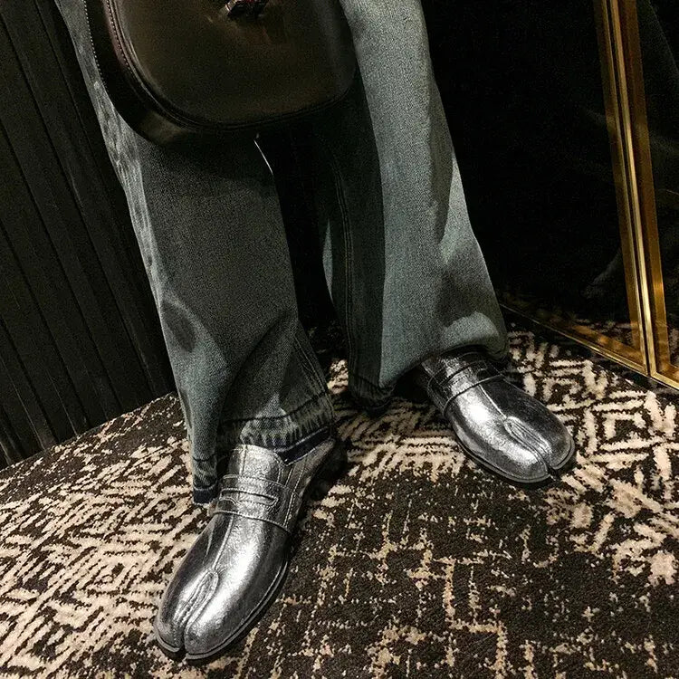 Shiny black leather dress shoes on feet with dark pants, perfect for genuine leather split style.