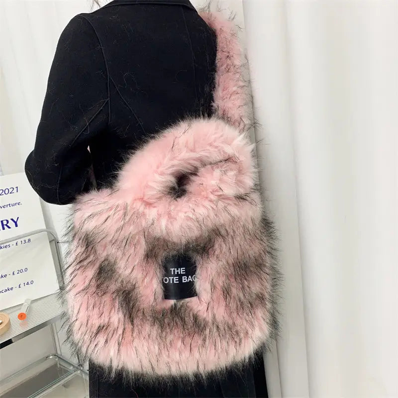 Pink fluffy faux fur crossbody tote bag with The label and large capacity design.