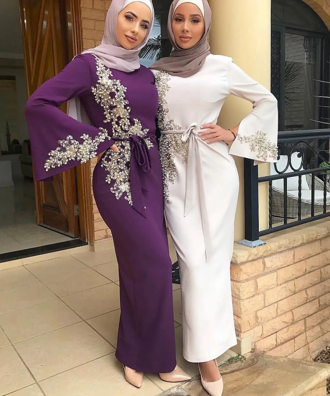 Two elegant ladies Muslim embroidered dresses with floral designs in purple and white.