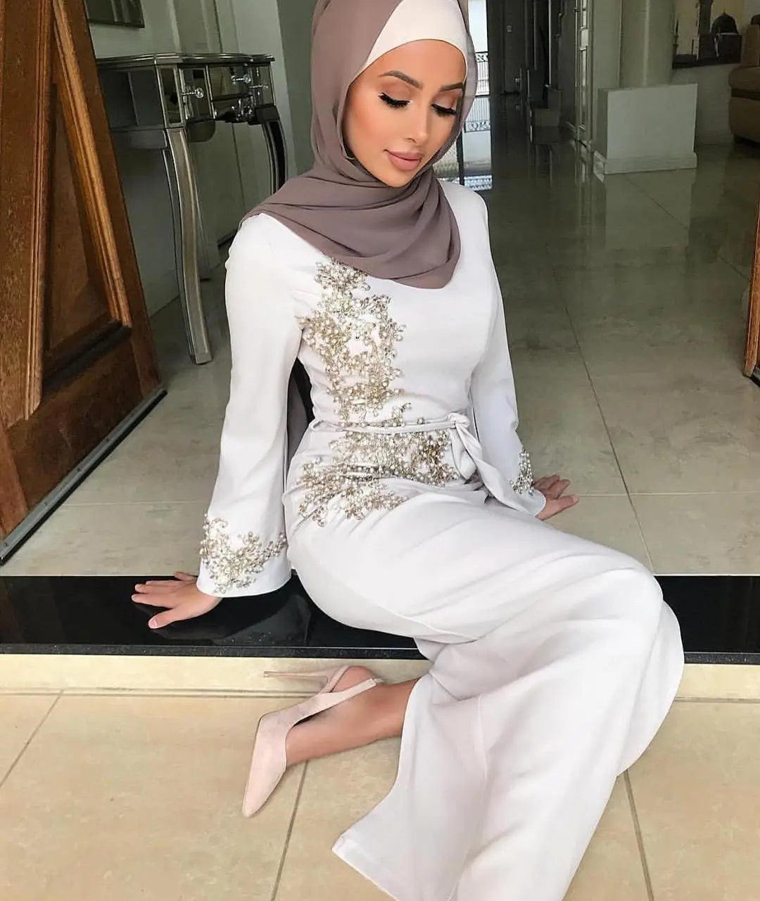 Elegant white jumpsuit with silver embellishments, perfect for ladies Muslim embroidered looks.