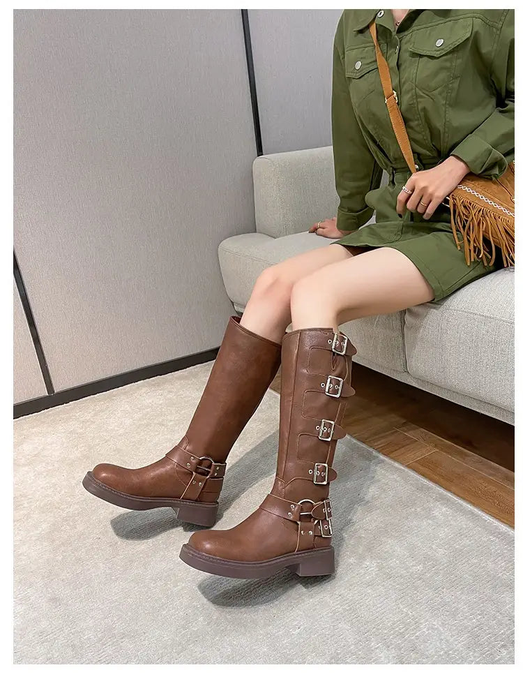 Brown leather chunky heel belt buckle boots with straps for stylish adventurers.