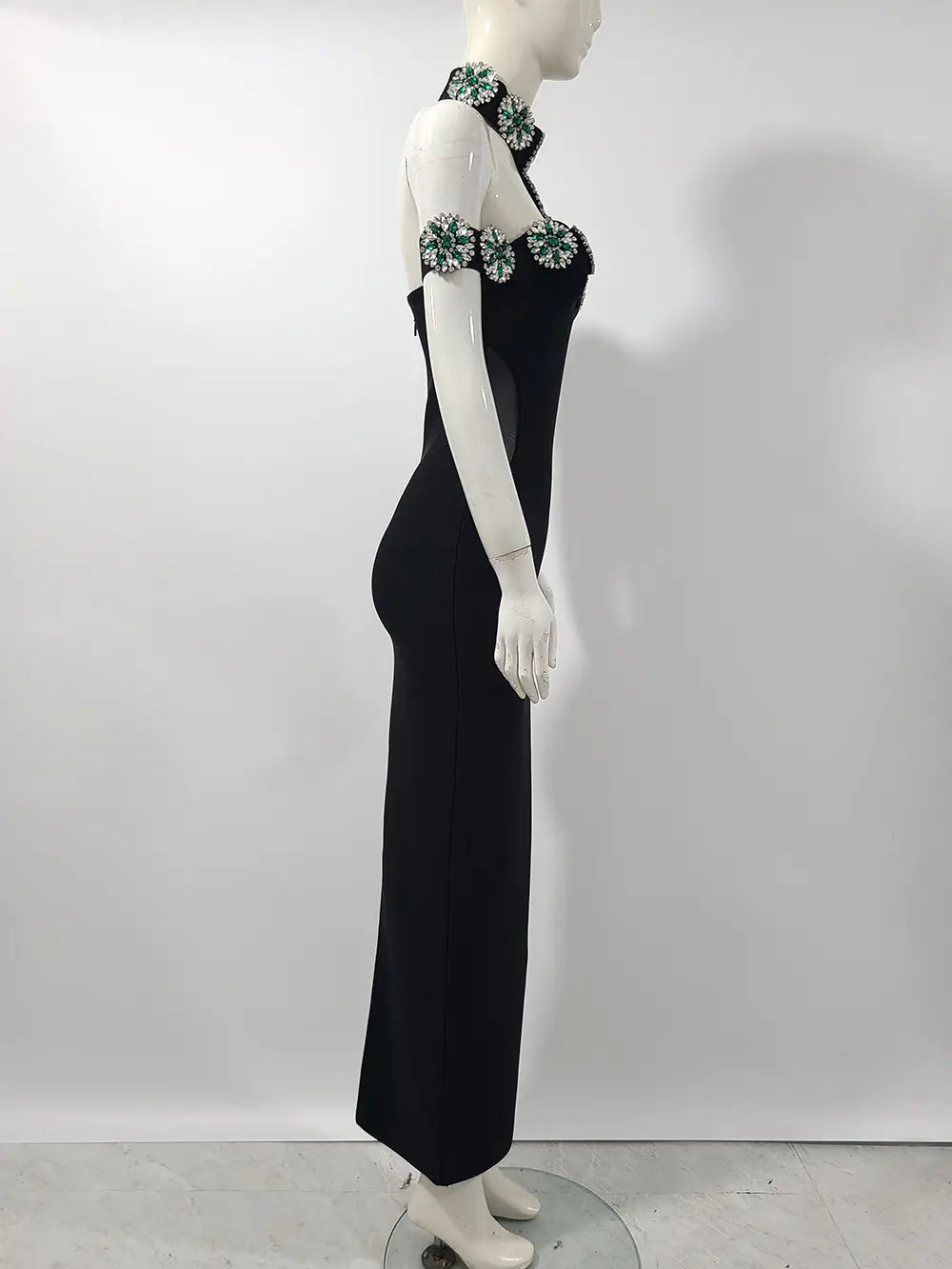 Black floor-length bandage dress with embellished halter neck for red carpet style.