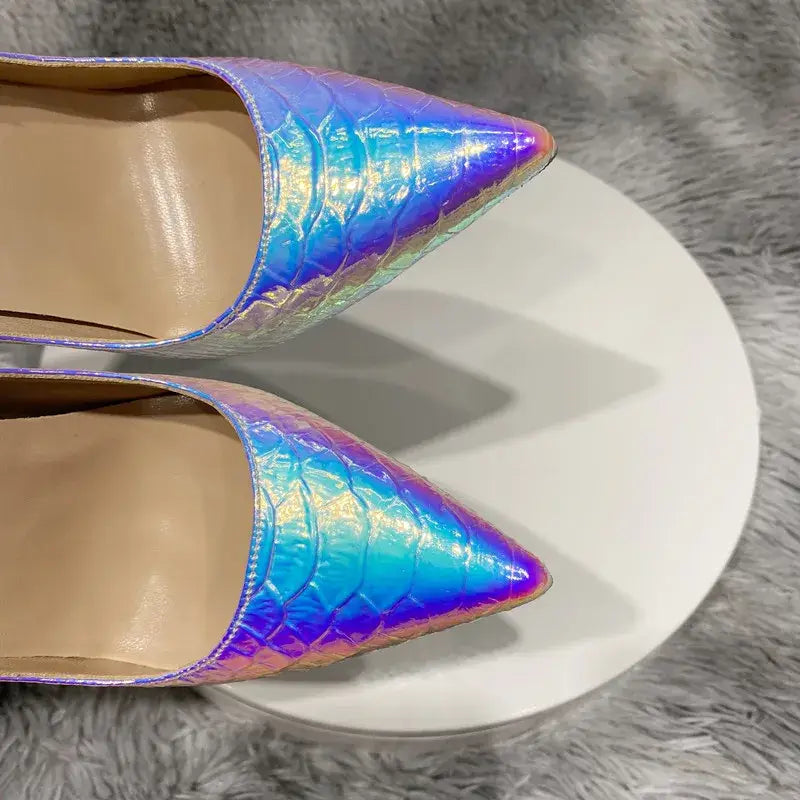 Iridescent holographic pointy toe high heels with a silver crocodile effect pattern.