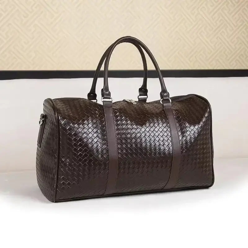 Brown leather woven duffle bag for unisex luggage and business trip carry on.