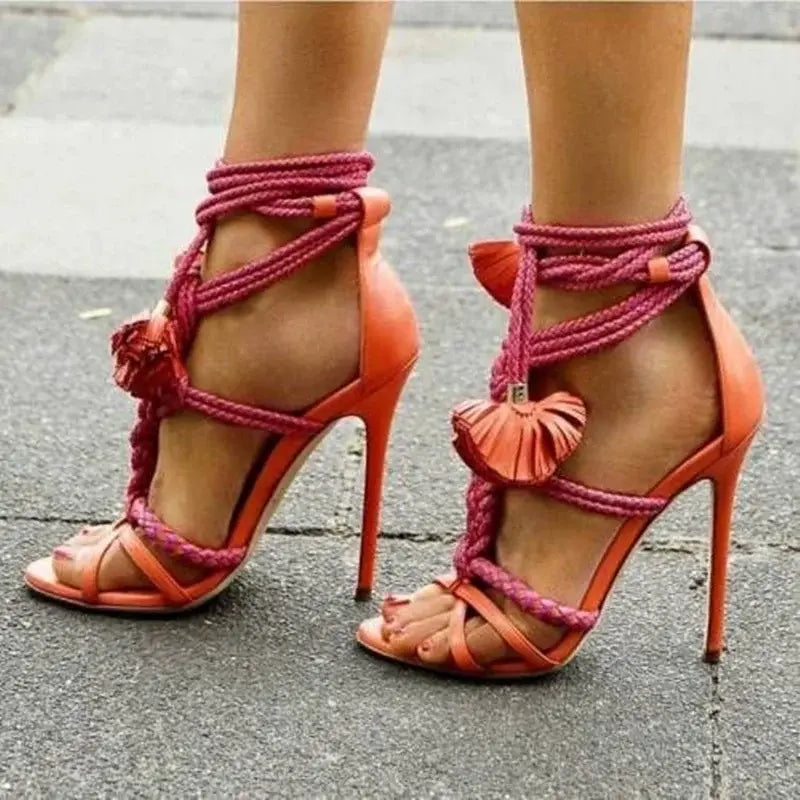 Coral high heel sandals with pink laces and flowers, perfect gladiator style for comfort.