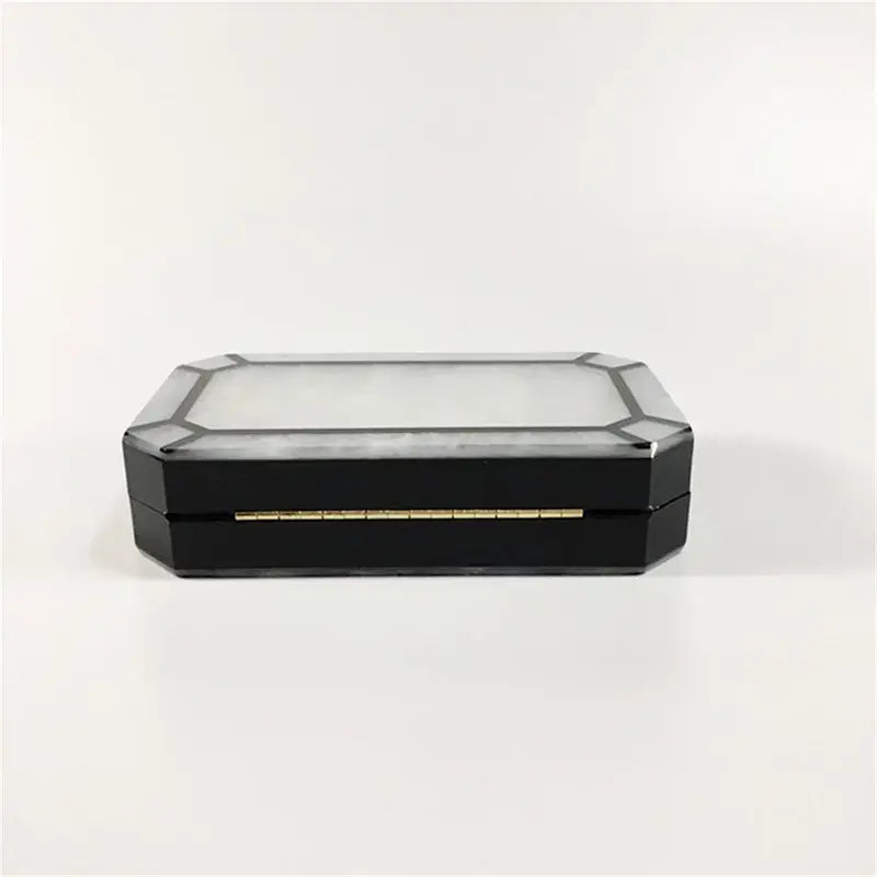 Black octagonal box with gold trim, part of Art Deco Design Womens Acrylic Evening Bag.