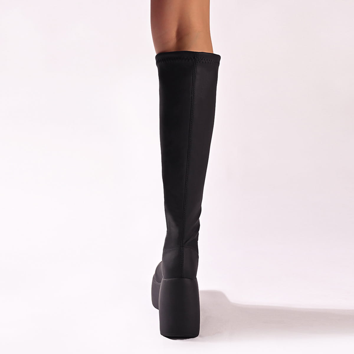 Black knee-high chunky platform elasticated boots with a stylish chunky heel.