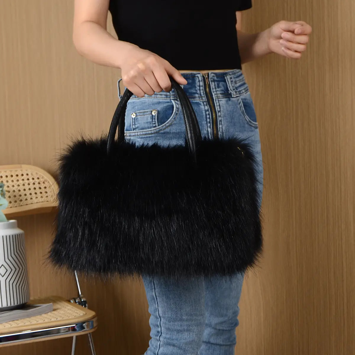 Black faux fur fluffy Boston handbag with handles, perfect for winter vibes.