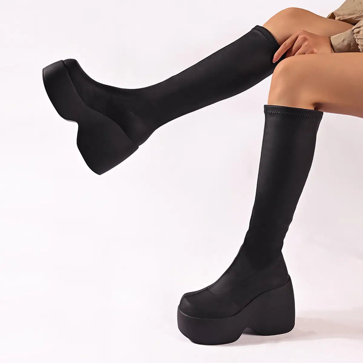 Black high chunky platform elasticated knee-length boots with a trendy chunky sole.