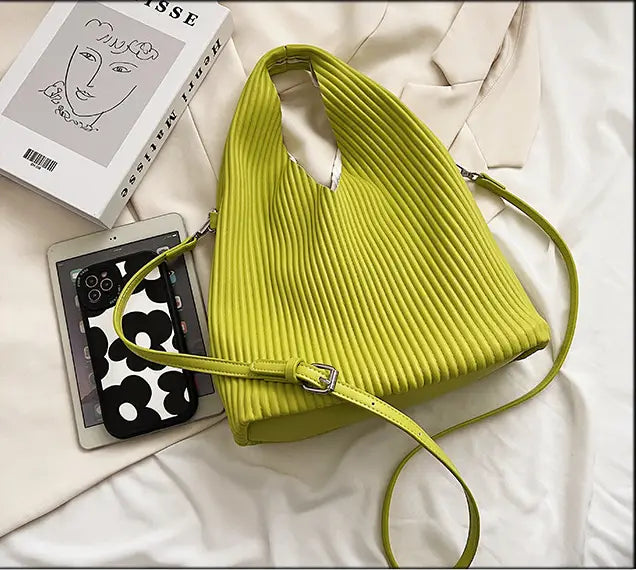 Lime green pleated shoulder bag with thin straps for women’s niche fashionable style.