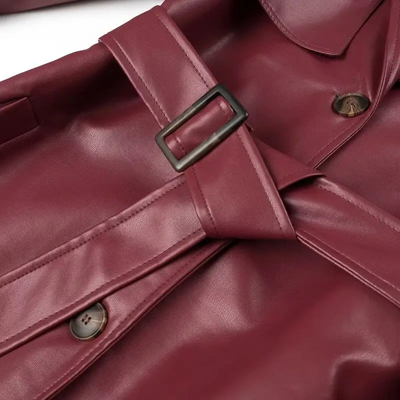 Burgundy ladies faux leather windbreaker coat with belt and buttons for timeless style.