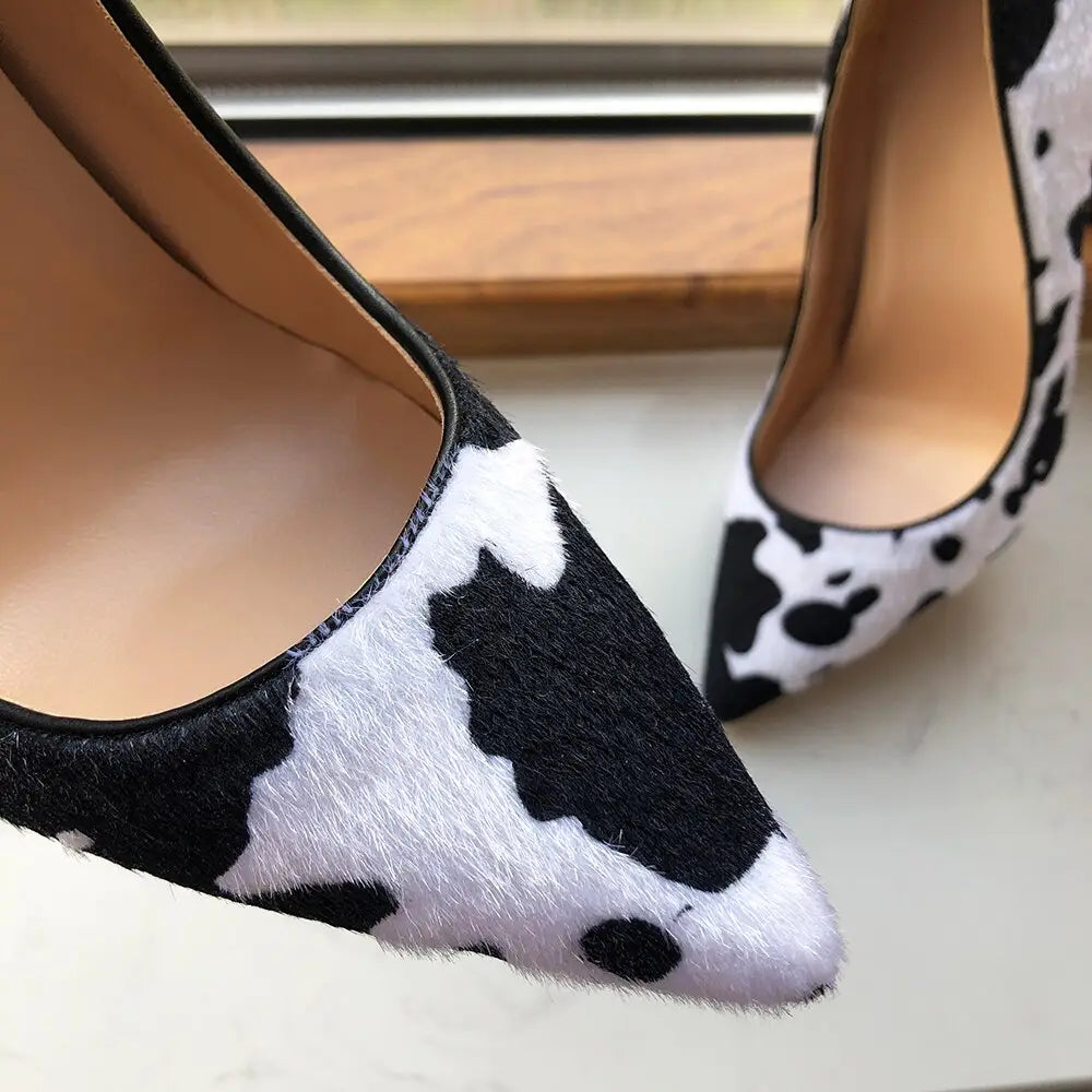 Pointed toe flats in black and white cow print hairy flock design for stylish vibes.