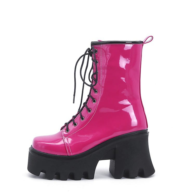 Hot pink patent boots with black soles, chunky tread, and thick heel short lace style.