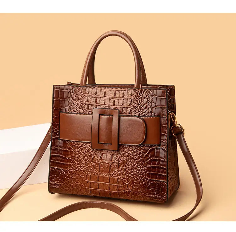 Brown womens crocodile shoulder crossbody tote bag with stylish buckle detail.