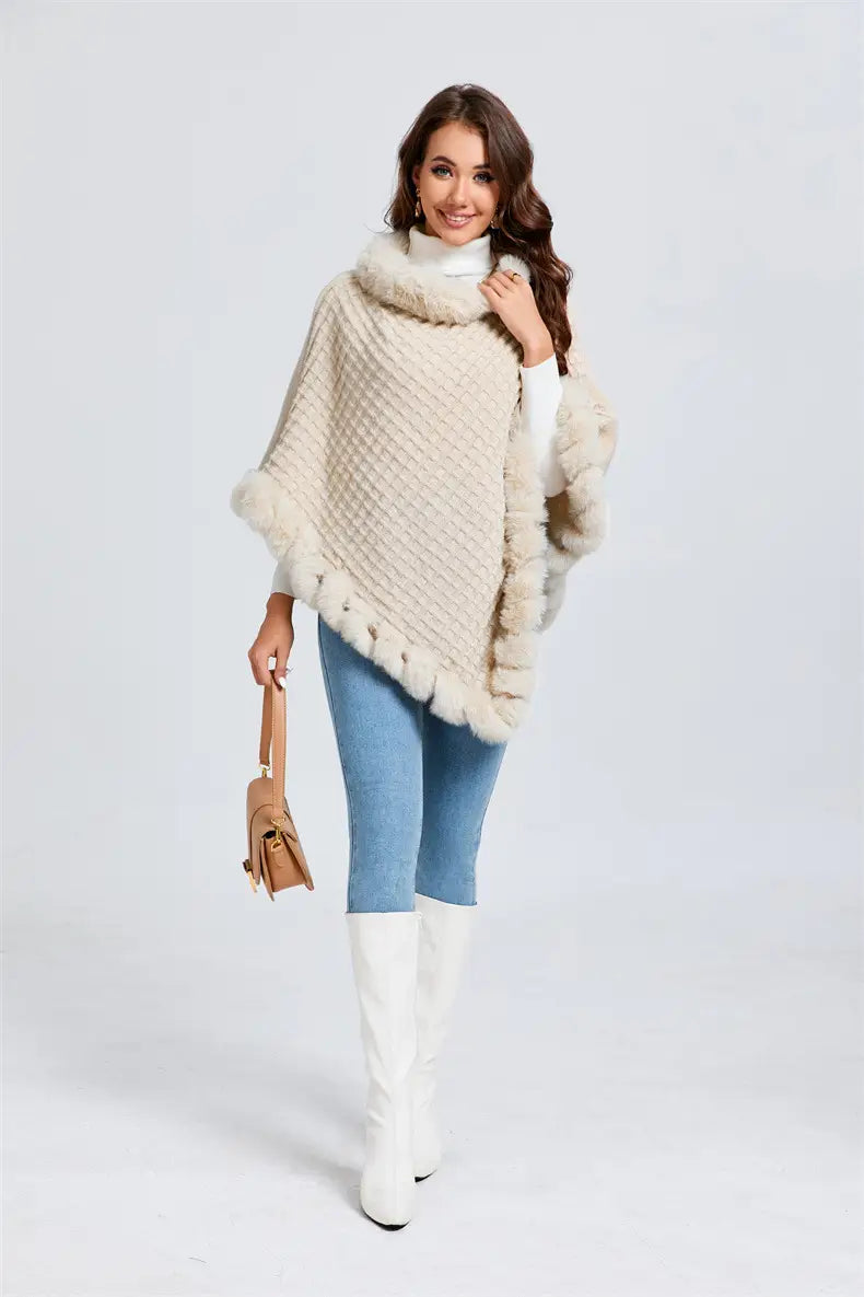 Cream-colored knit poncho with faux fur collar, styled with jeans and white boots.