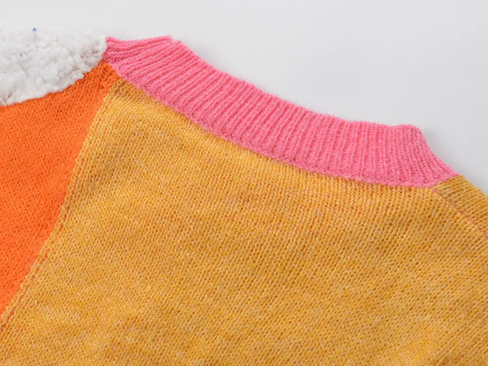 Colorblock knit Ladies Rainbow Cloud Short Sweater in pink, orange, and yellow patchwork.