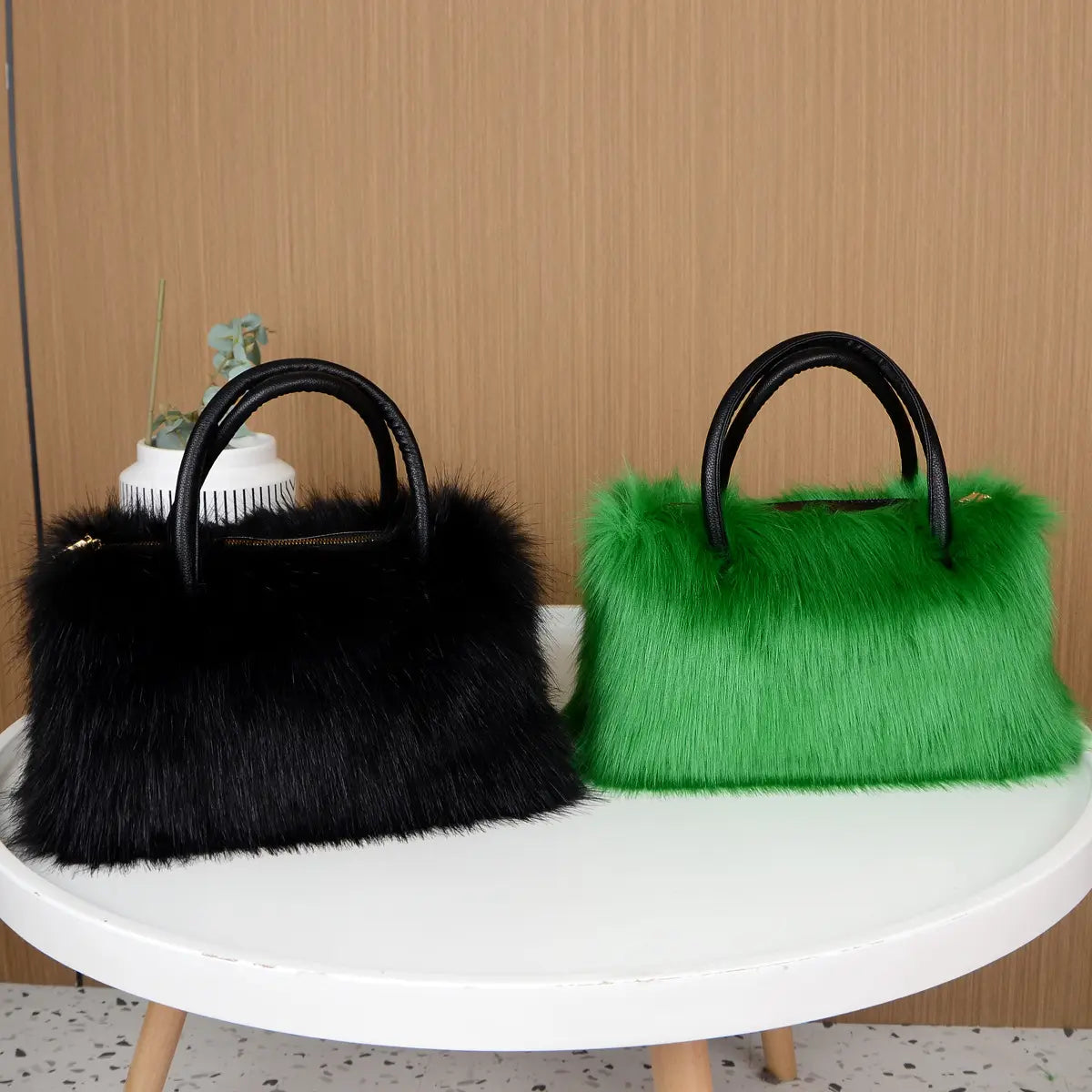 Two furry handbags in black and bright green, perfect faux fur fluffy Boston handbag for winter vibes.