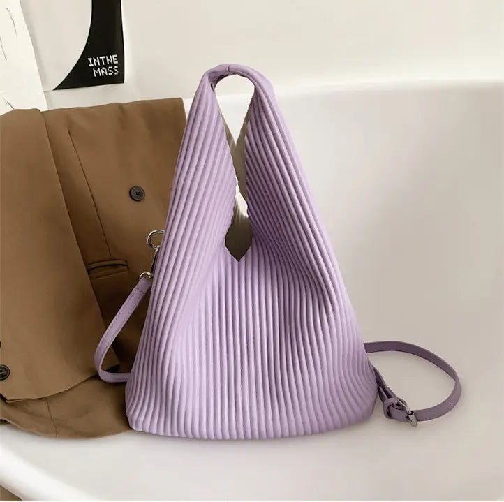 Pleated lavender triangle handbag as part of a women’s niche fashionable collection.