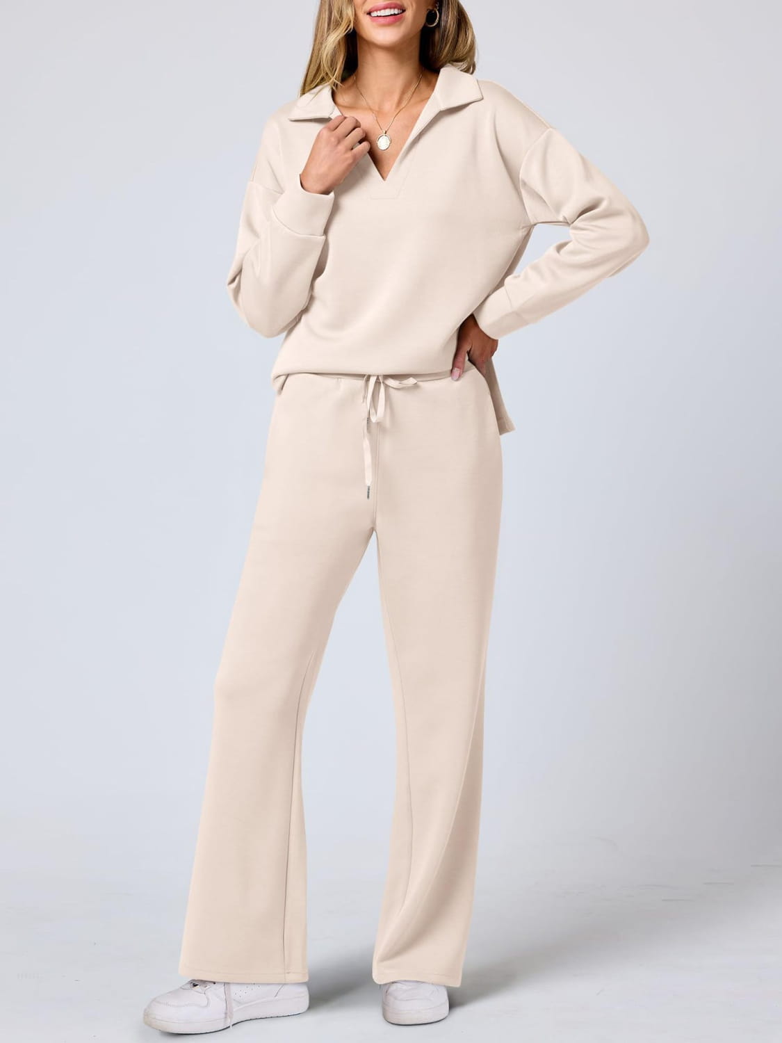 Cream-colored ladies two piece casual outfit set with pockets and flared pants.