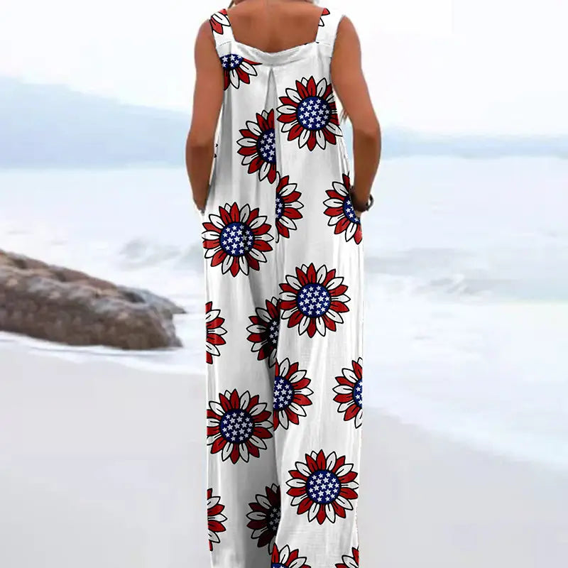 White sleeveless maxi dress featuring a vibrant red, blue, and black sunflower print design.