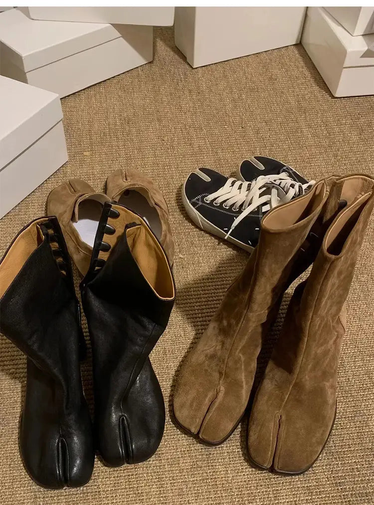 Three pairs of footwear, including genuine suede split toe tabi boots on carpet.