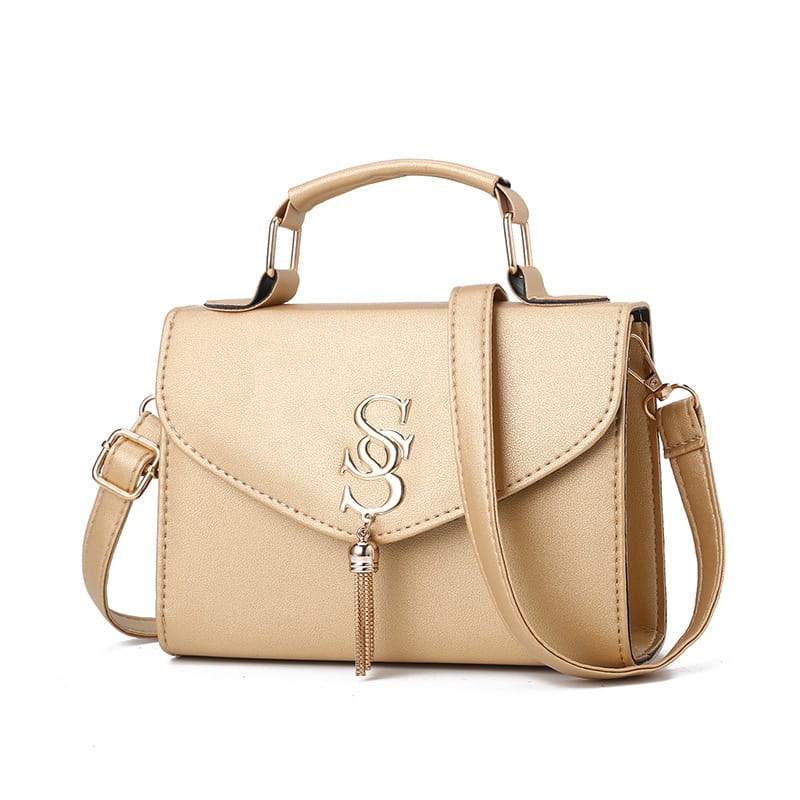 Beige leather fashion shoulder messenger handbag with tassel and strap for everyday style.