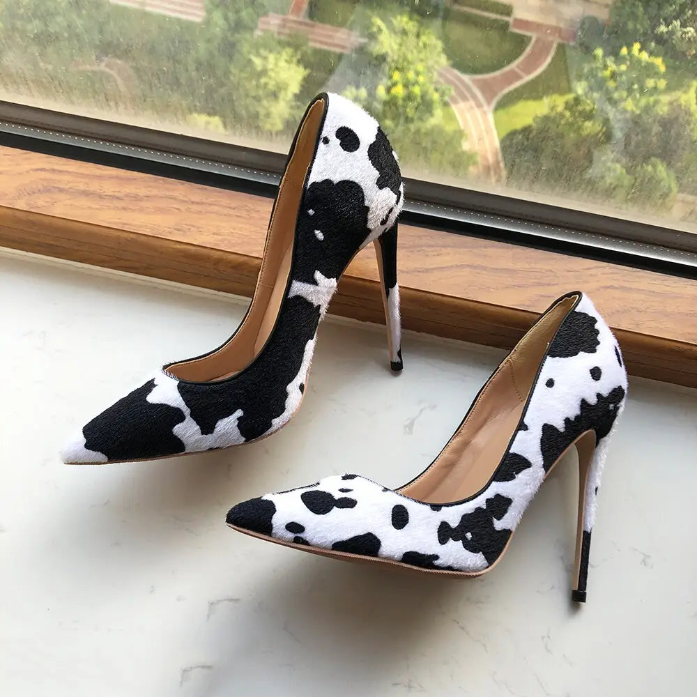 High-heeled pumps in black and white cow print hairy flock pointed toe style.