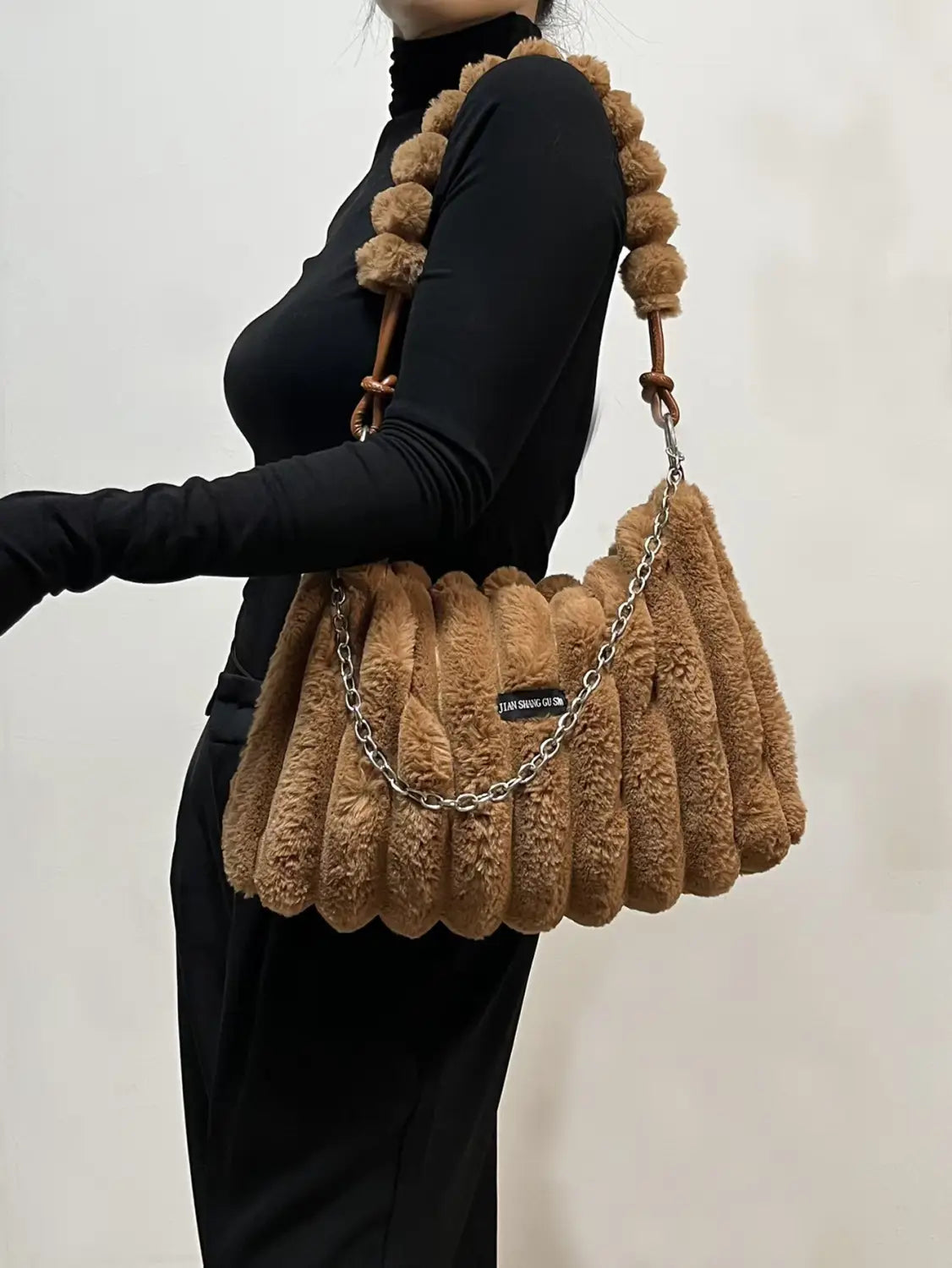 Plush brown handbag with furry pleats and beaded handle, perfect for ladies plush retro style.