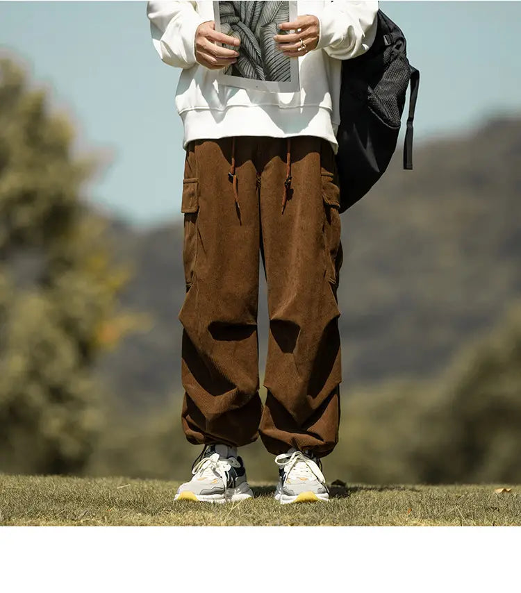 Brown corduroy cargo pants with stylish black patches and multiple pockets for casual comfort.