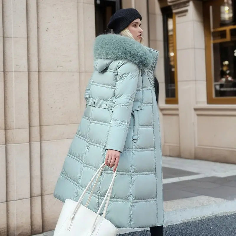 Mint green ladies long padded coat with luxurious fur-trimmed hood for winter style.