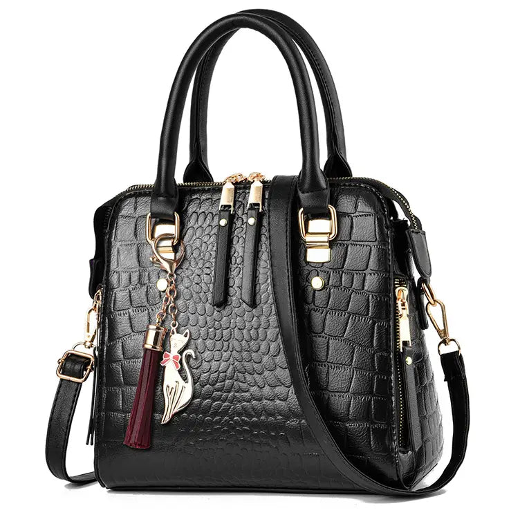 Black crocodile-textured handbag with gold accents, perfect ladies crocodile print crossbody shoulder bag.