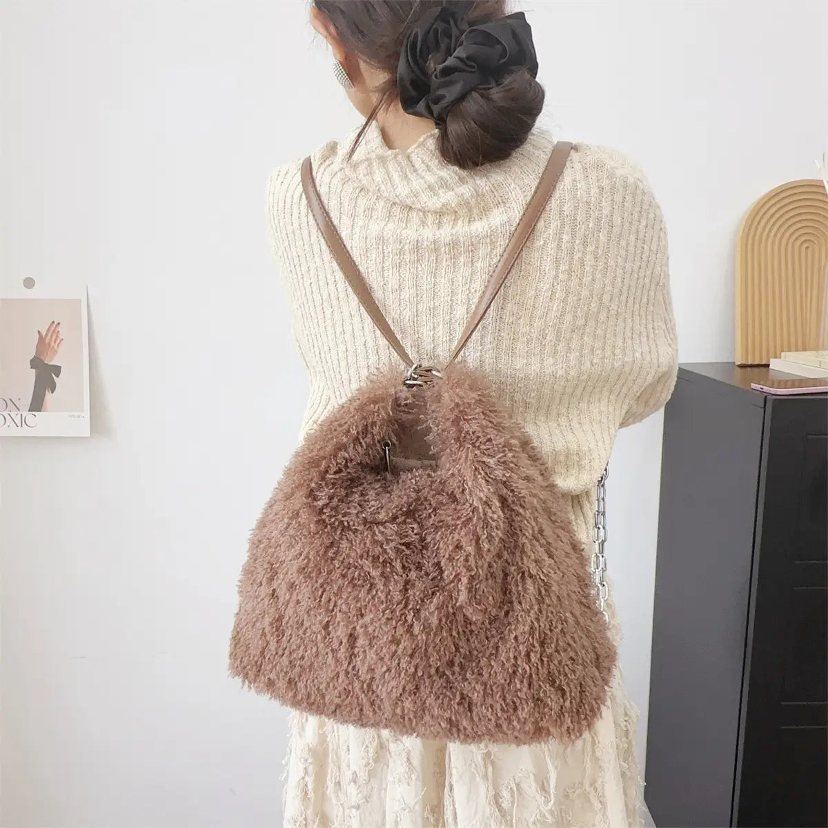 Fluffy brown faux fur backpack with leather straps, a plush large capacity shoulder bag.