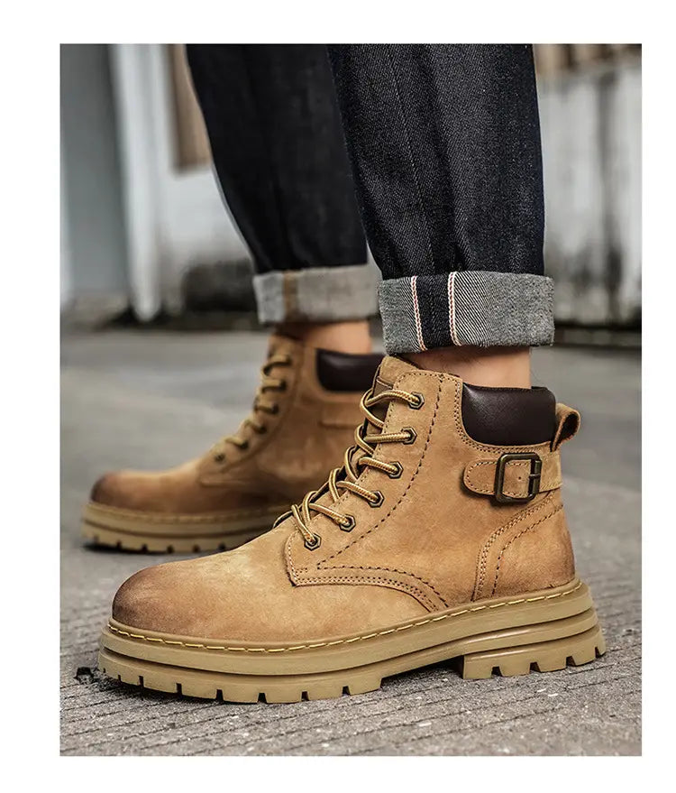 Tan Retro Martin Boots with thick rubber soles paired with rolled-up dark denim jeans.