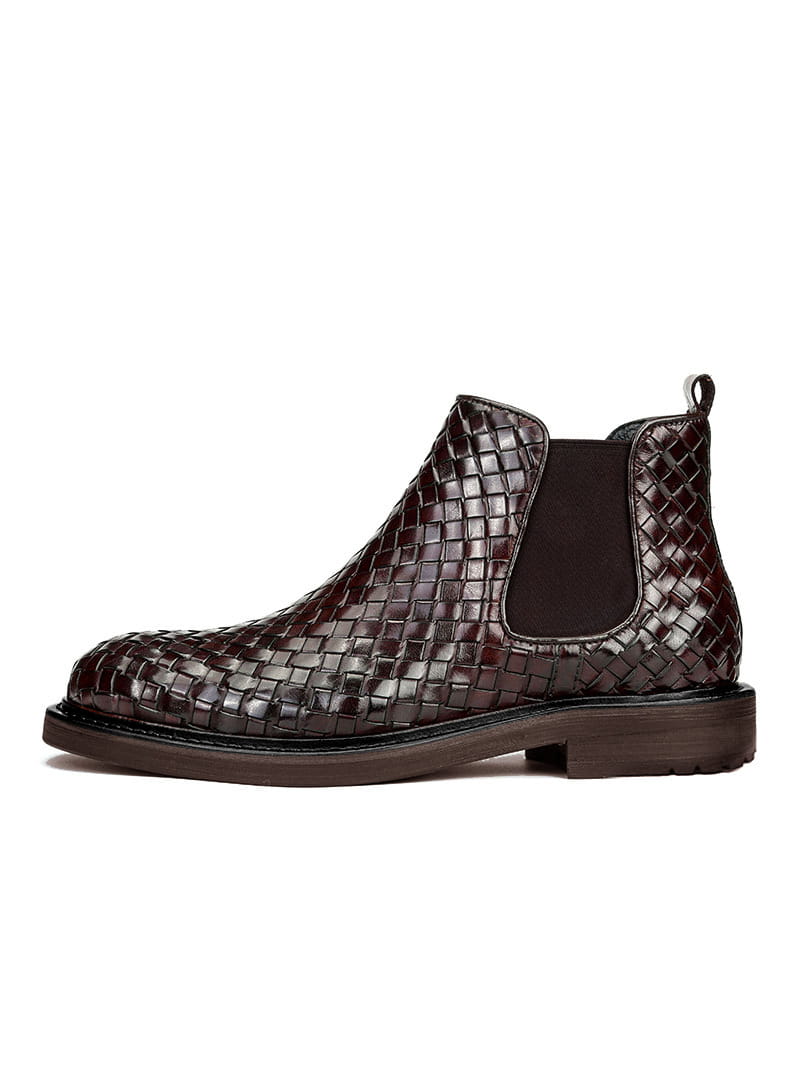 Dark brown men’s woven pattern Chelsea boots with elastic panels and chunky sole.