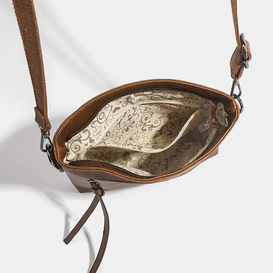 Brown leather crossbody bag showcasing high-end textured artificial retro style with fun lining.