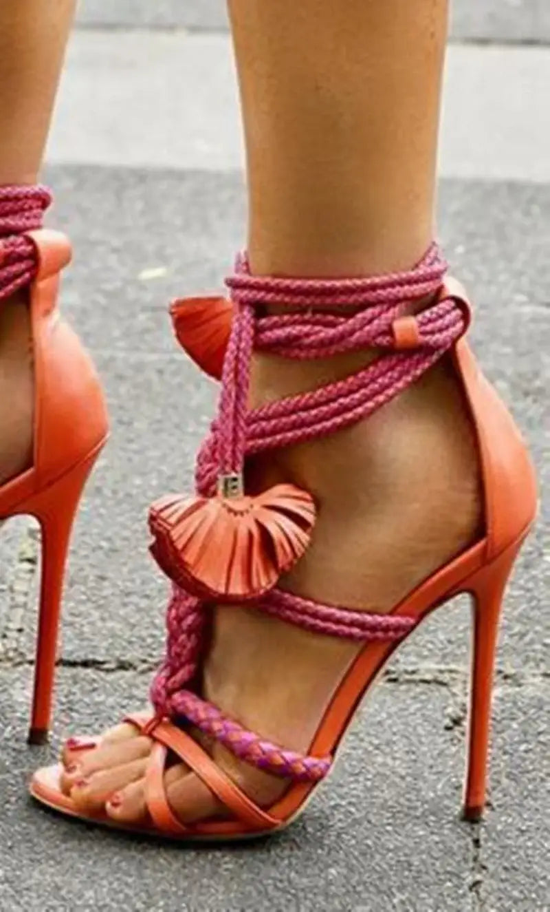 Coral braided strap high heel gladiator sandals with pink rope laces and tassel detail.