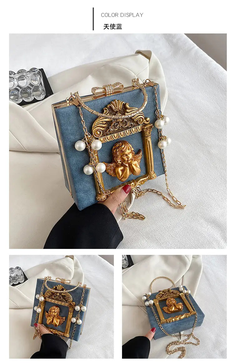 Ornate blue velvet shoulder chain bag with gold frame, pearls, and cherub detail.