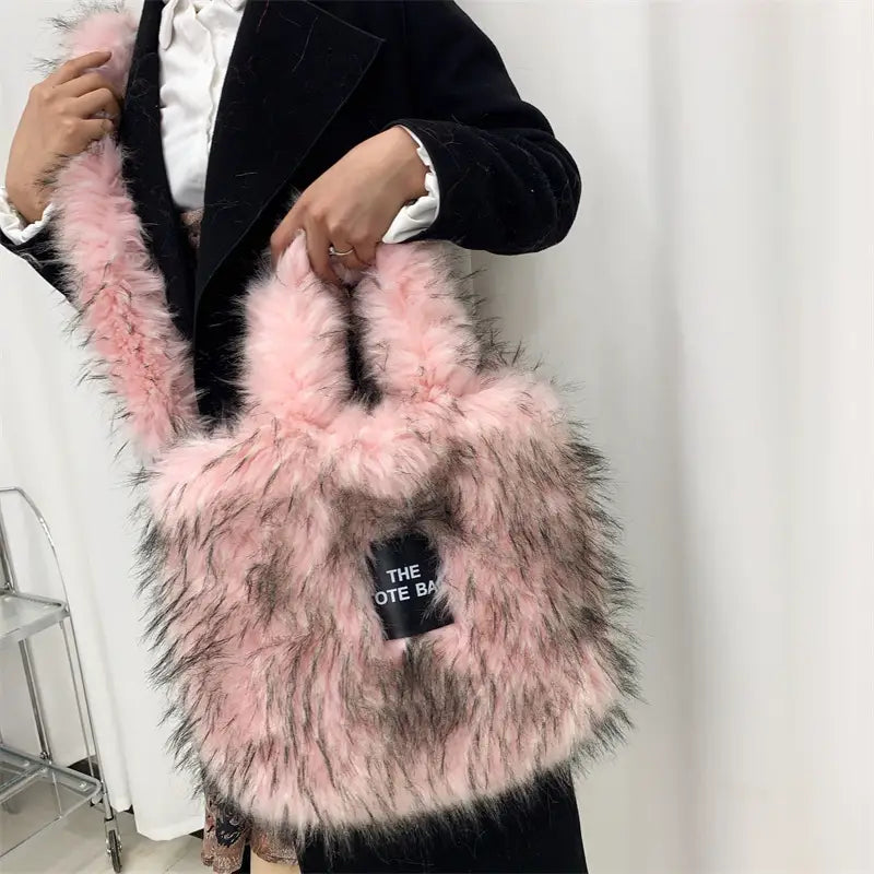 Pink furry crossbody tote bag with black logo patch and large capacity for stylish storage