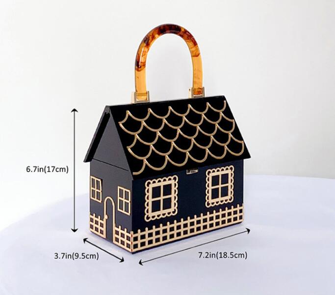 Black house shaped handbag with luxury designer acrylic handle and gold scalloped trim.