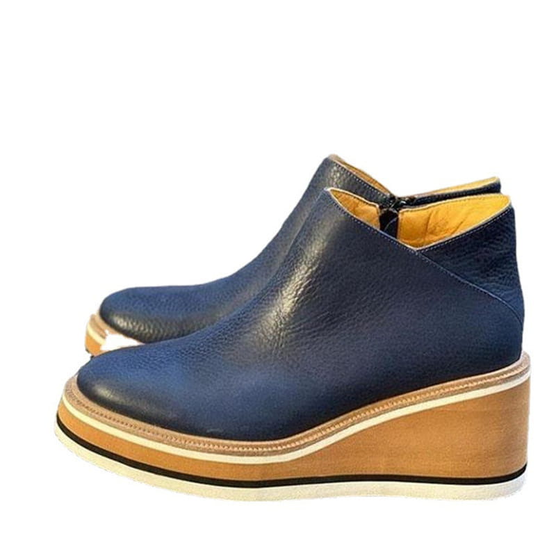 Navy blue leather surface ankle boots with tan wedge, perfect zipper mid heel style.