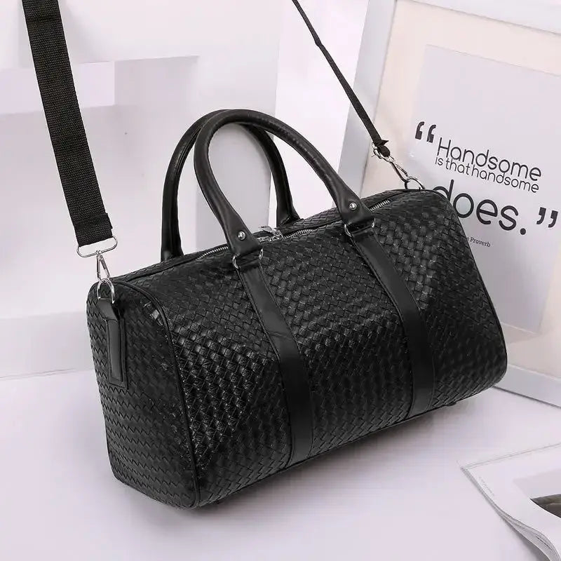 Black woven leather duffle bag perfect for business trip carry and unisex luggage needs.