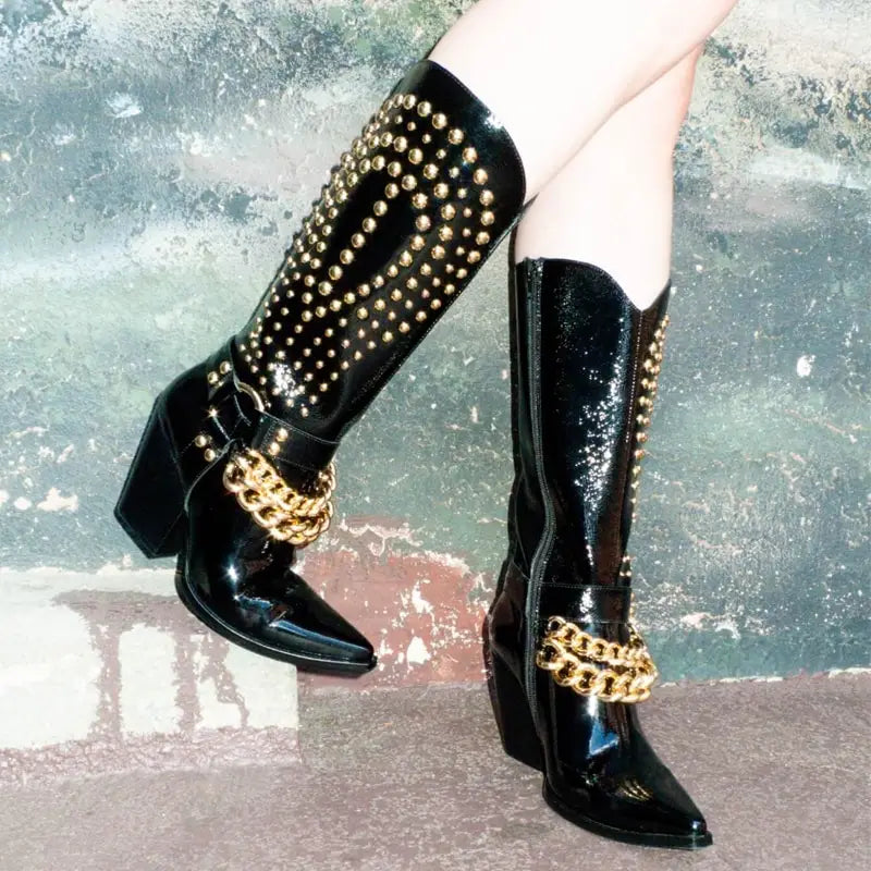 Stylish Black Patent Leather Western Cowboy Boots with Rivet Belt Buckle and Gold Accents.