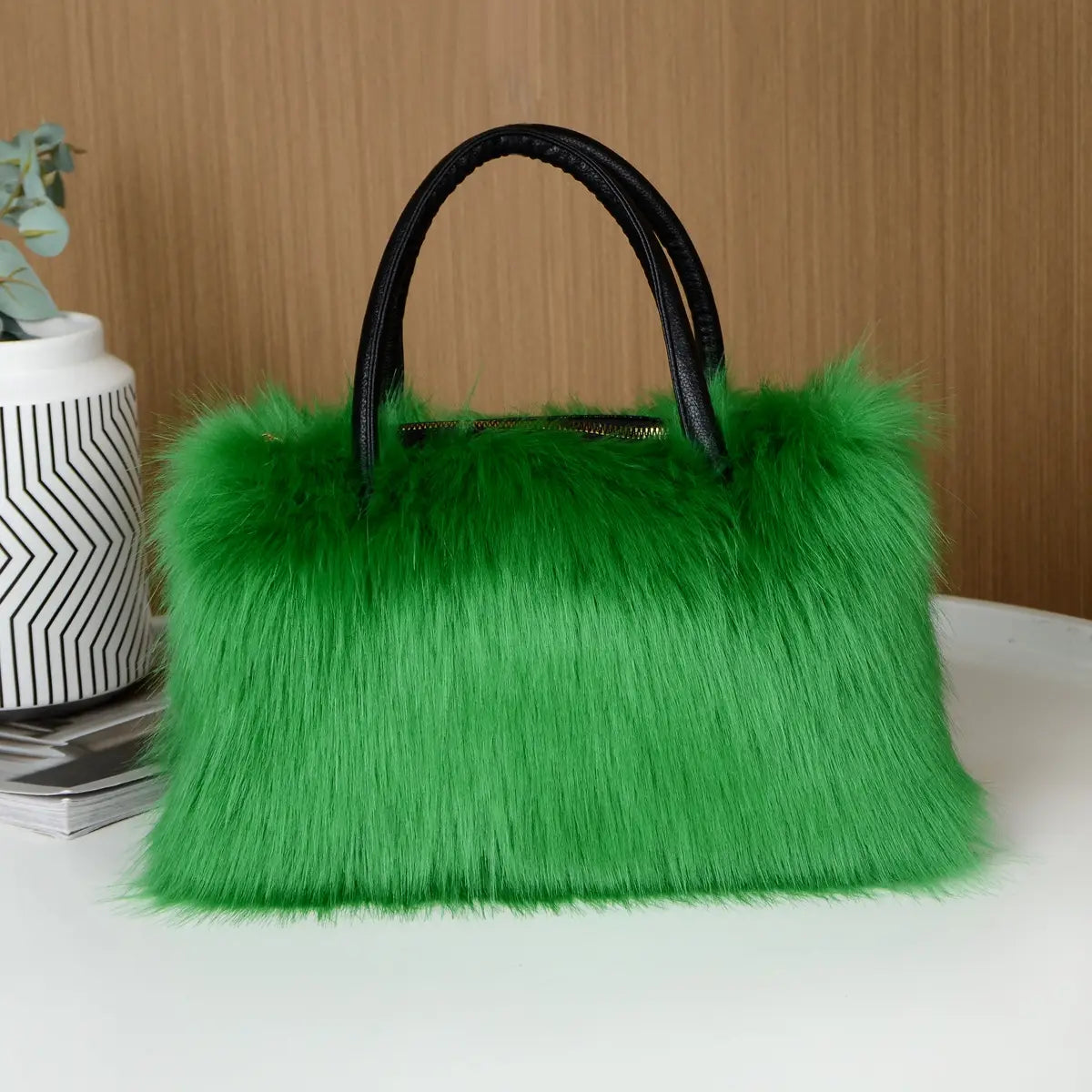 Bright green faux fur fluffy Boston handbag with black handles for winter vibes.