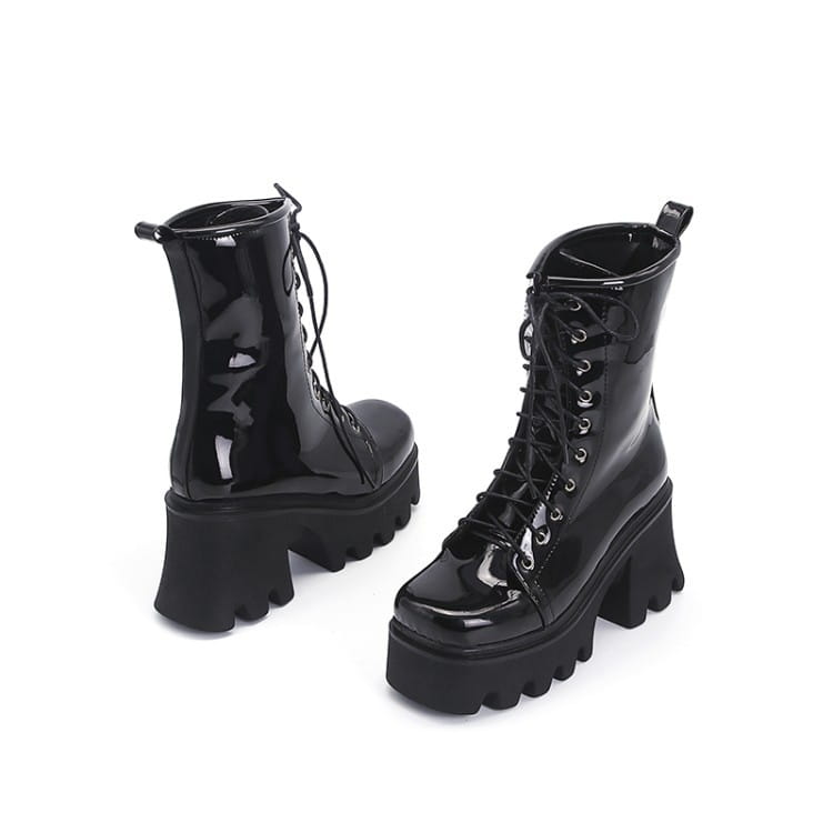 Black patent boots with chunky soles and lace-up fronts for a stylish look.