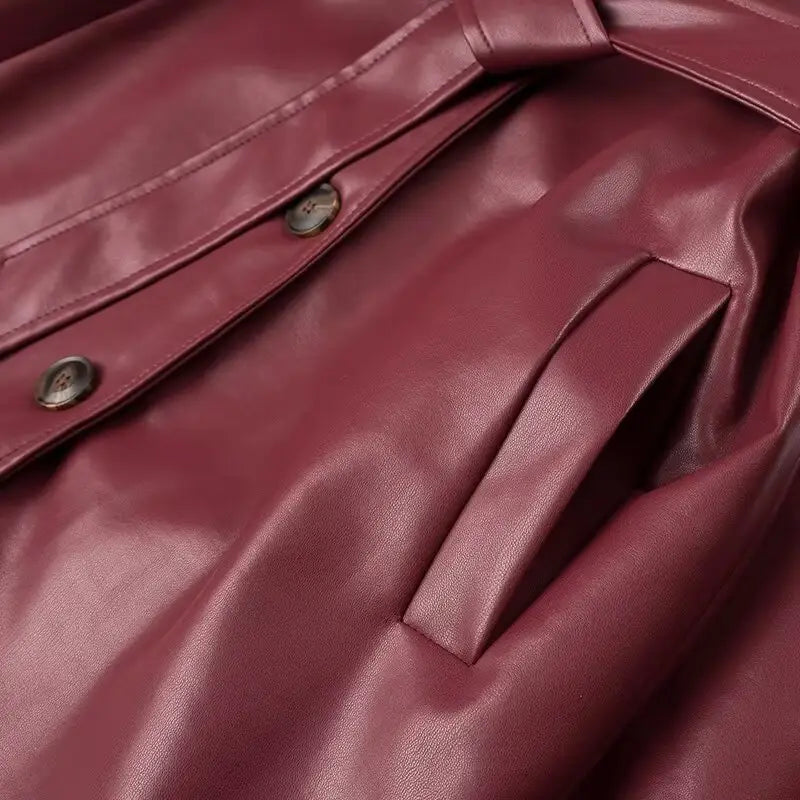 Burgundy ladies faux leather windbreaker coat with stylish metal snap buttons.