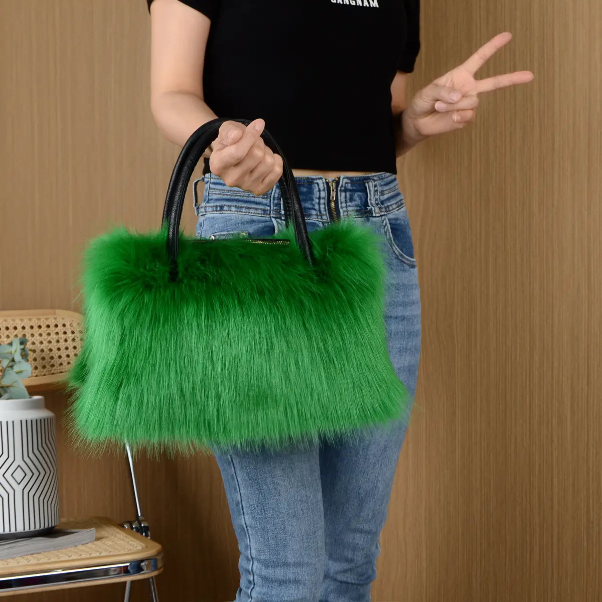 Bright green faux fur fluffy Boston handbag with black handles for winter vibes.