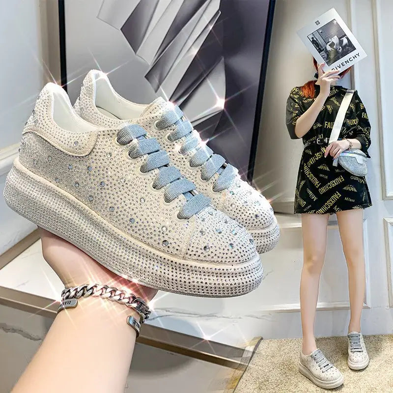 White rhinestone bling sneaker with light blue laces and thick sole lace for leisure.