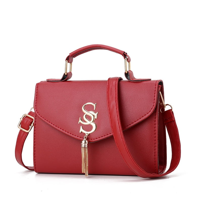 Red leather shoulder messenger handbag with gold tassel and S embellishment for stylish fashion.