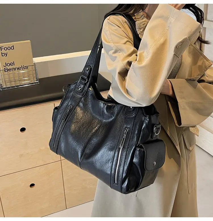 Stylish Black Leather Ladies Multi Zip Shoulder Travel Messenger Bag with compartments.