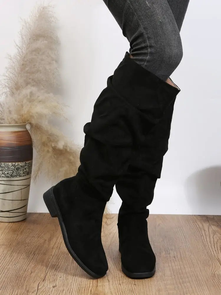 Black faux suede knee-high boots featuring stylish ruched detailing for ladies.